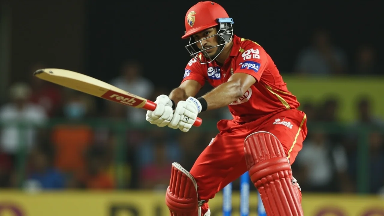 A top-order batter plays on the off-side during an evening IPL fixture, framed tight on the stroke and intent
