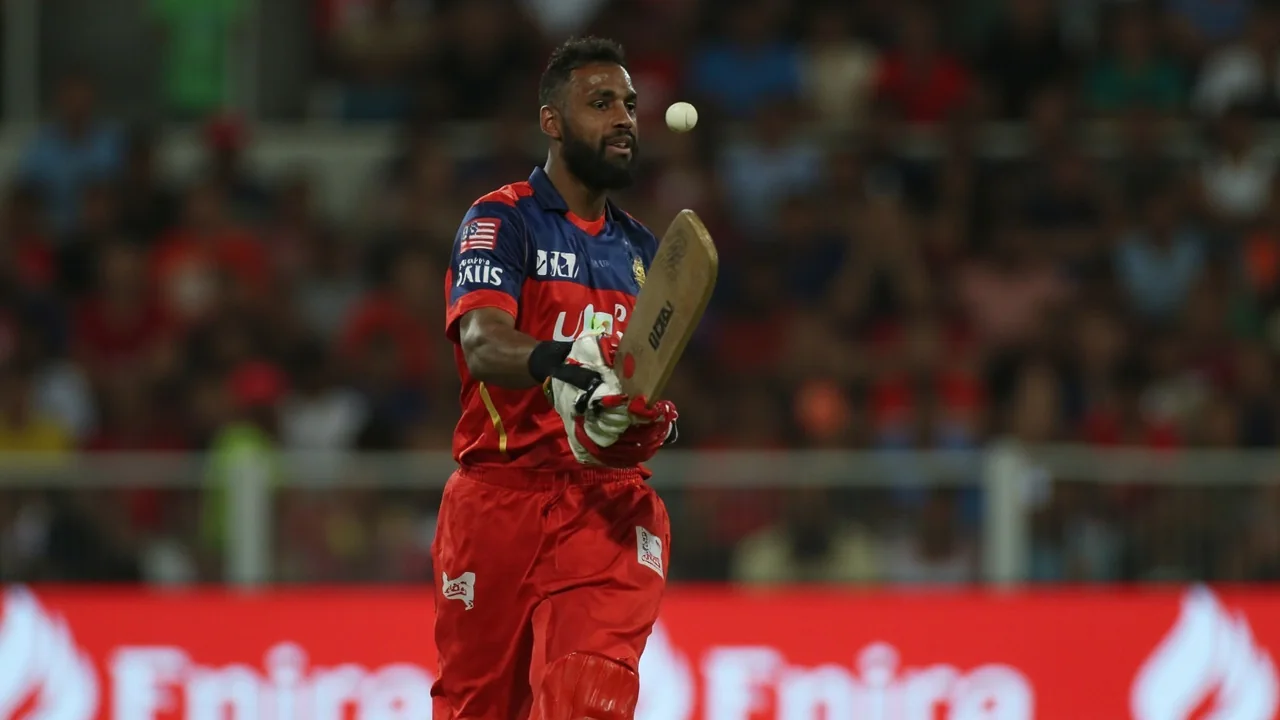 Wide view of a floodlit Indian cricket stadium on a match night, capturing the pre-auction mood of the IPL 2023 retention window
